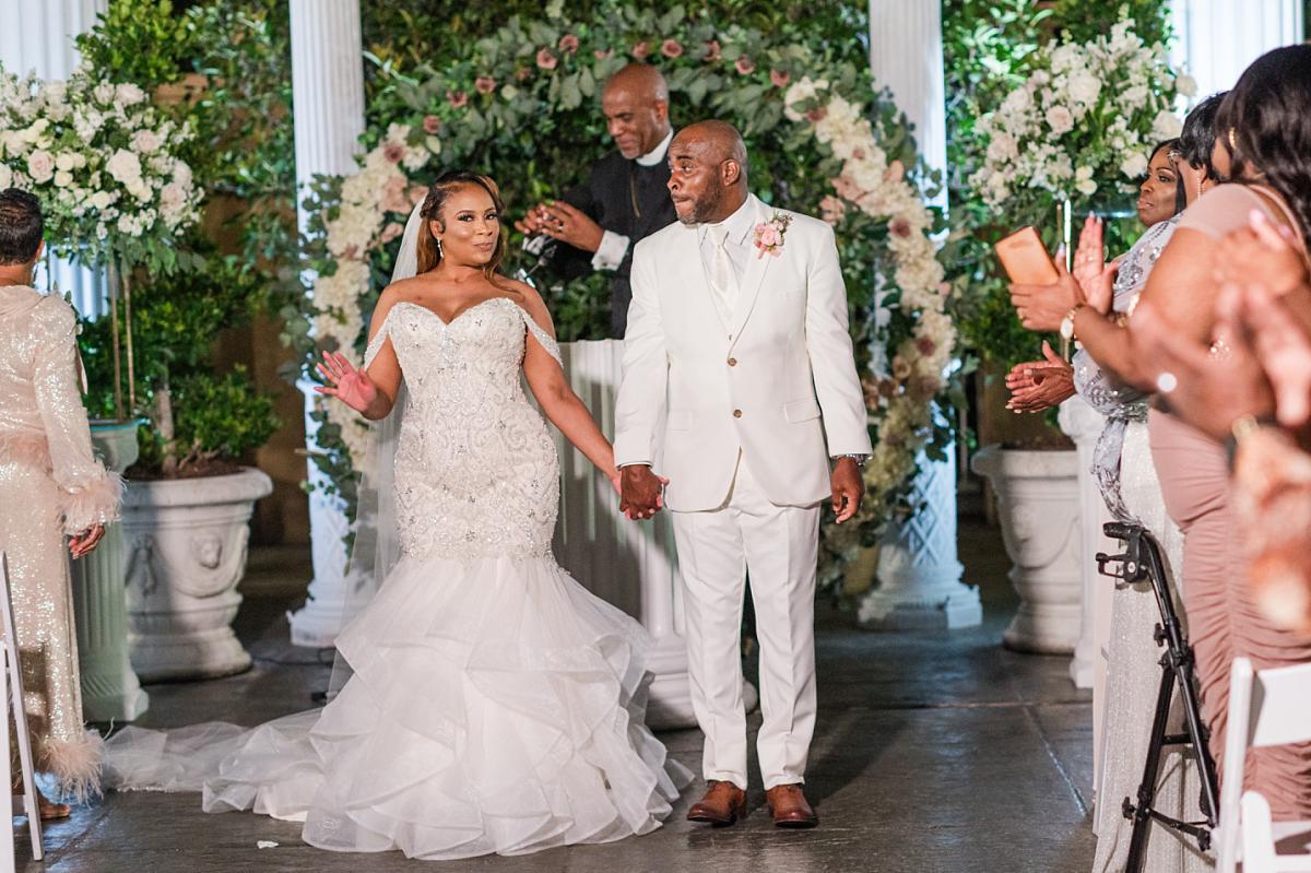 The new couple pause for a second at their Champagne Palace wedding