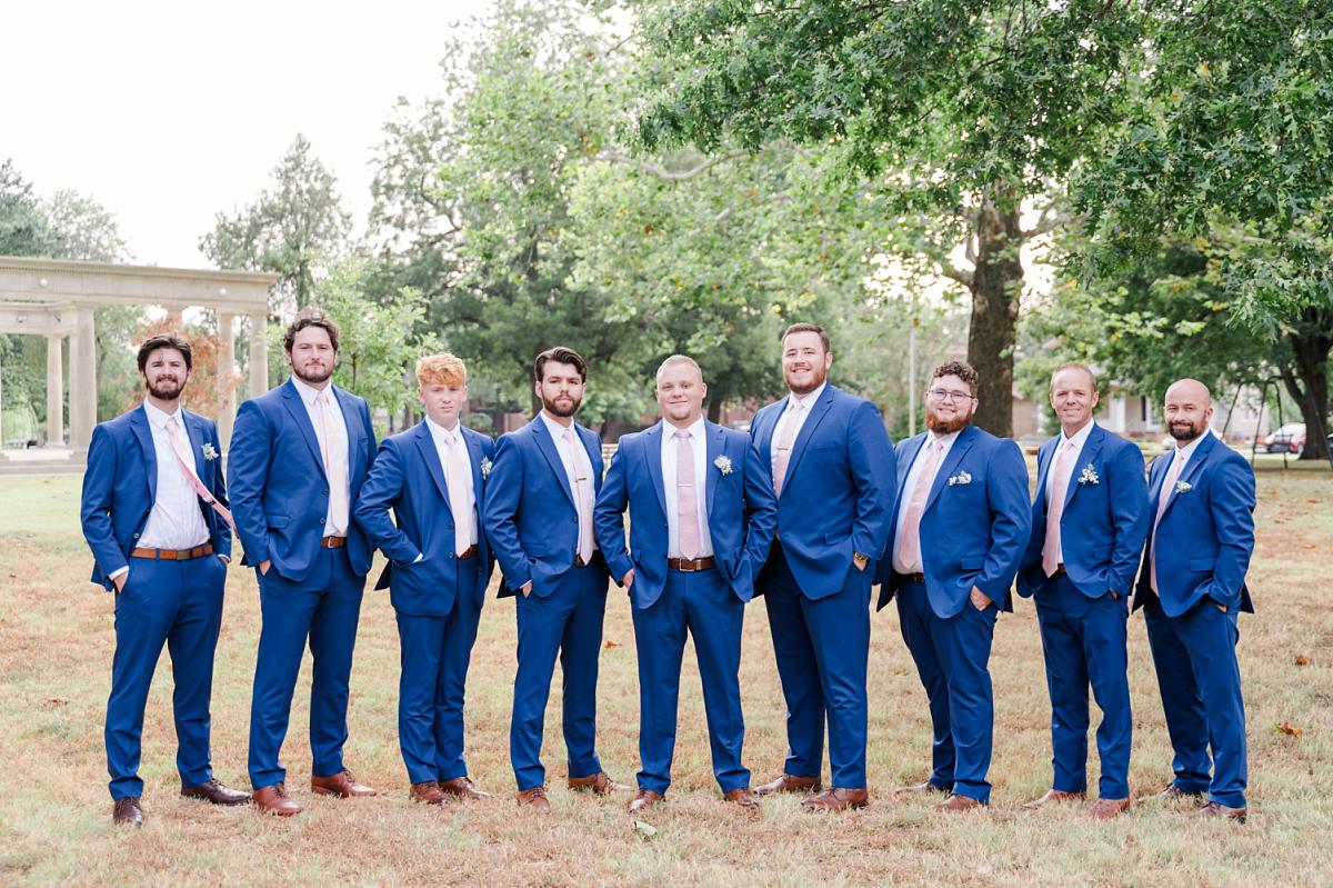 Groomsmen pose in Bywaters Park located in Paris Texas