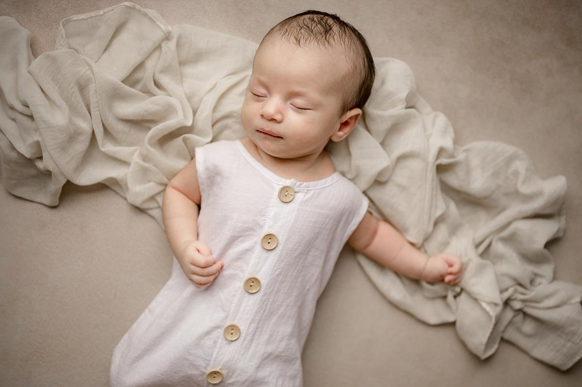 Professional newborn photography in Houma showcasing a 2-month-old baby’s milestone moments