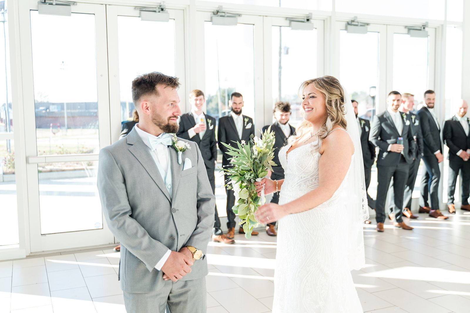 First Look moment with bride and groom at Jean Lafitte Auditorium entrance