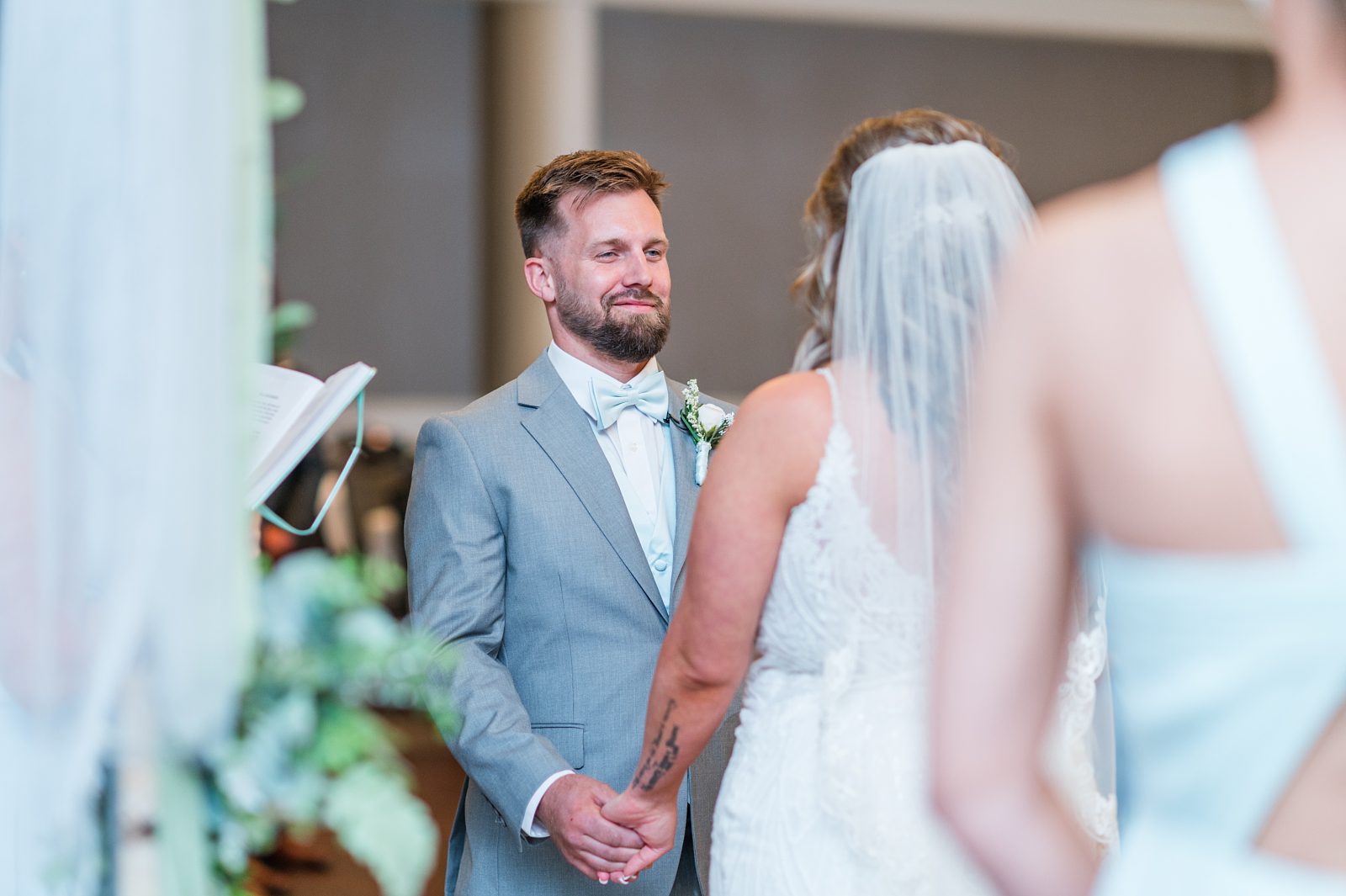 Groom smiling during wedding vows at Jean Lafitte Auditorium